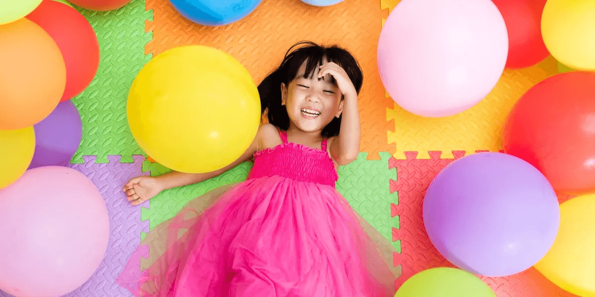 Child playing with balloons